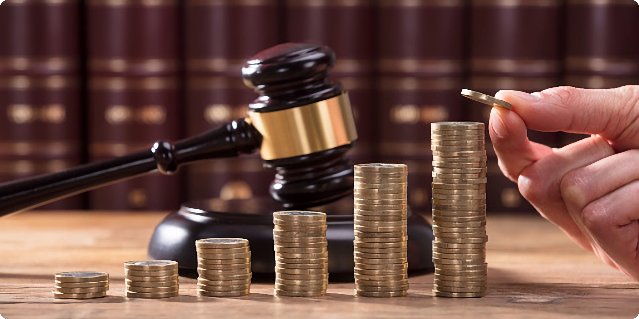 Gavel behind coins
